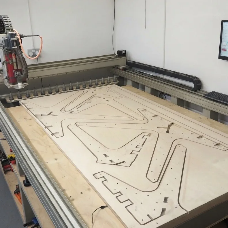 CNC router panel nesting: cabinet parts nested and cut from a plywood sheet